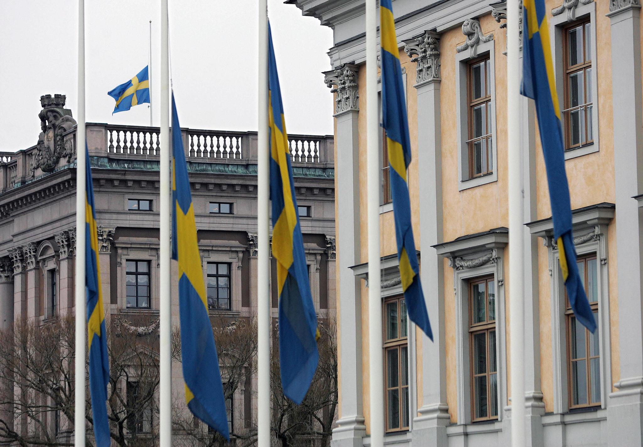 Swedish flags outside the Foreign Ministry and on top of the Riksdag, the parliament building, in Stockholm are lowered to half mast, 01 January 2004