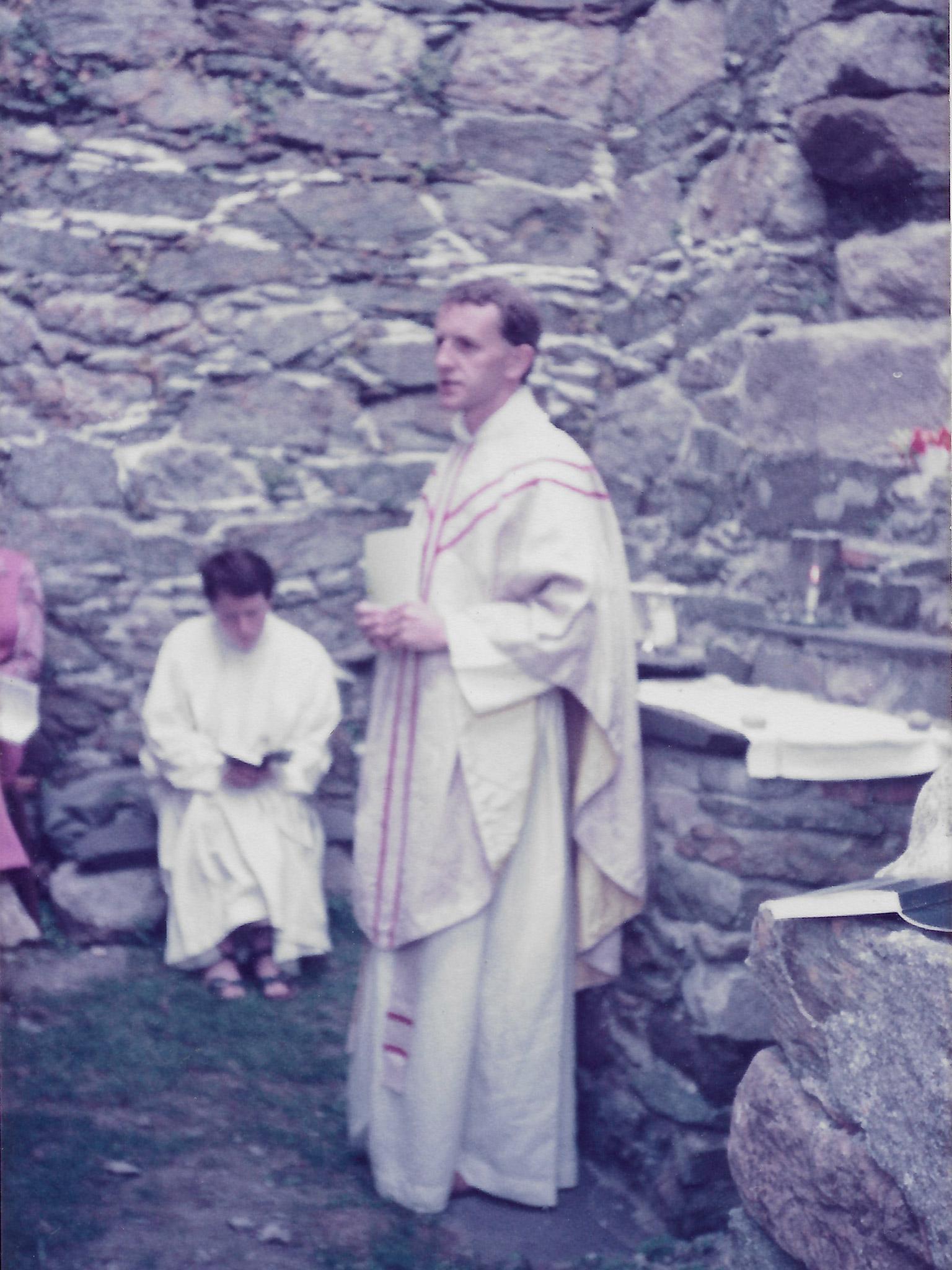 Simon leading mass in the ruined abbey of Barsey, 1984
