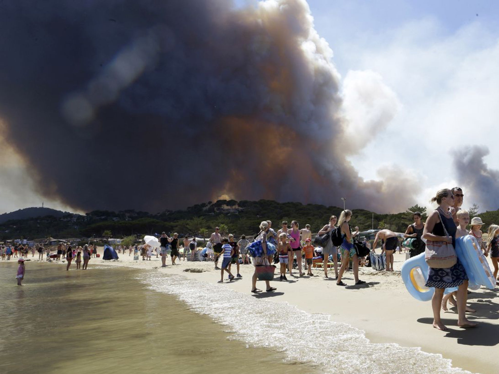 Tourists were evacuated to a beach as the fires threatened the Mediterranean coast