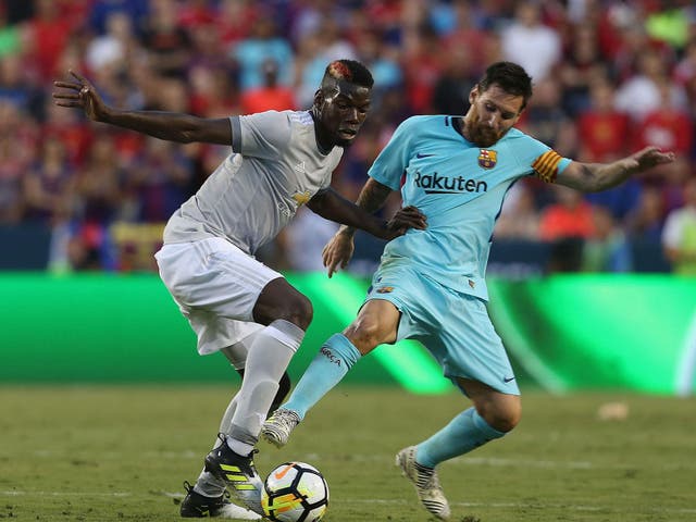 Paul Pogba in action against Lionel Messi (Manchester United)