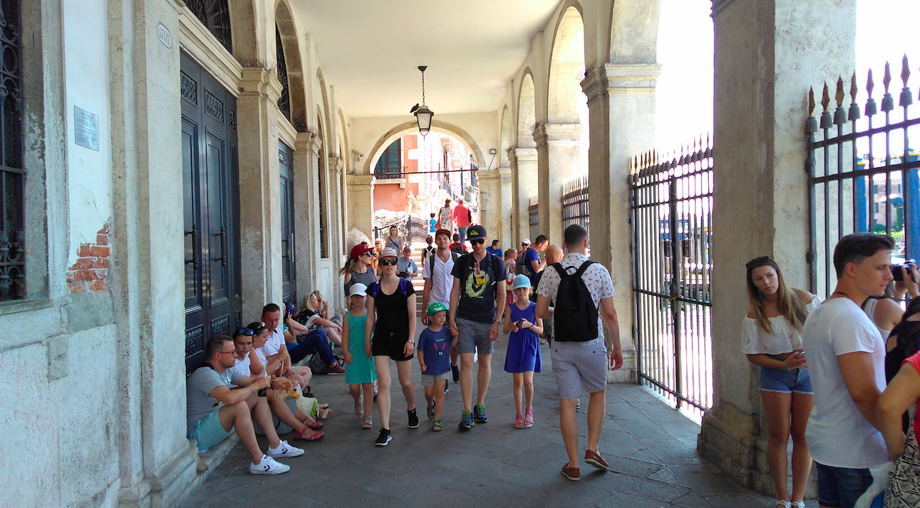 Tourists commandeer steps and doorways as seats in July