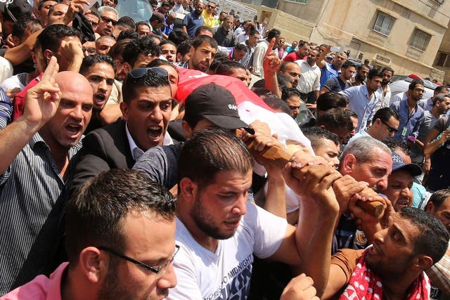 Mourners carry the body of 17-year-old Mohammed Jawawdeh