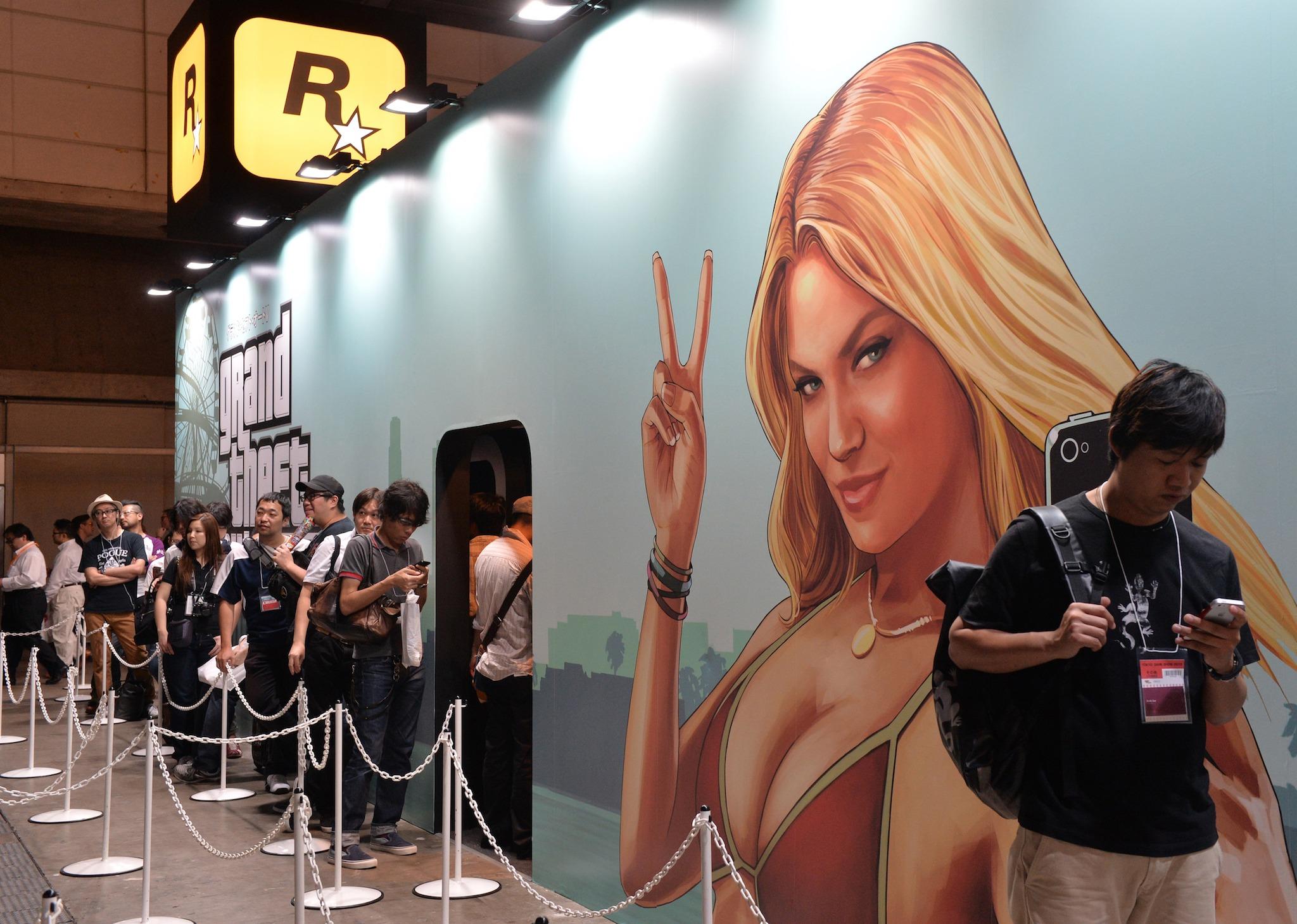 Visitors queue to play the new Rockstar Games videogame "Grand Theft Auto V"