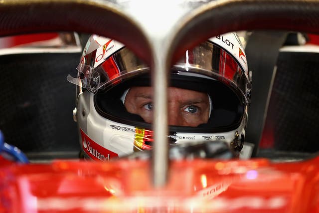 Sebastian Vettel, pictured sitting behind the 'halo' on his Ferrari