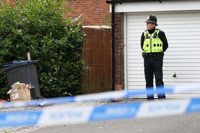 Police at the scene where armed officers shot a man in Hereford Close, Frankley, Birmingham.