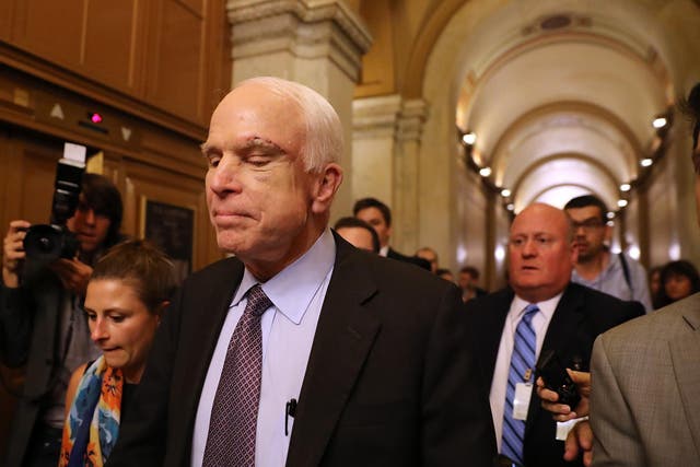 John McCain leaves the Senate chamber after voting against the Republican 'skinny repeal' healthcare bill
