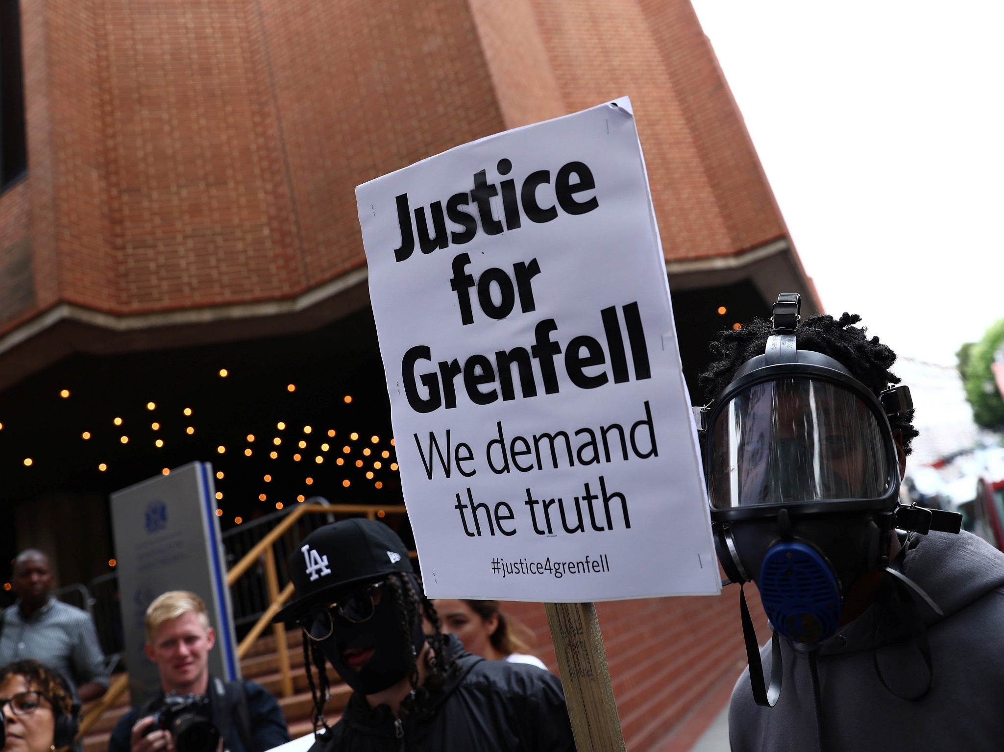 Demonstrators protest against the Grenfell Tower fire outside a Kensington and Chelsea Council meeting at Kensington Town Hall