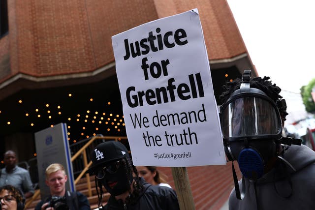 Demonstrators protest against the Grenfell Tower fire outside a Kensington and Chelsea Council meeting at Kensington Town Hall