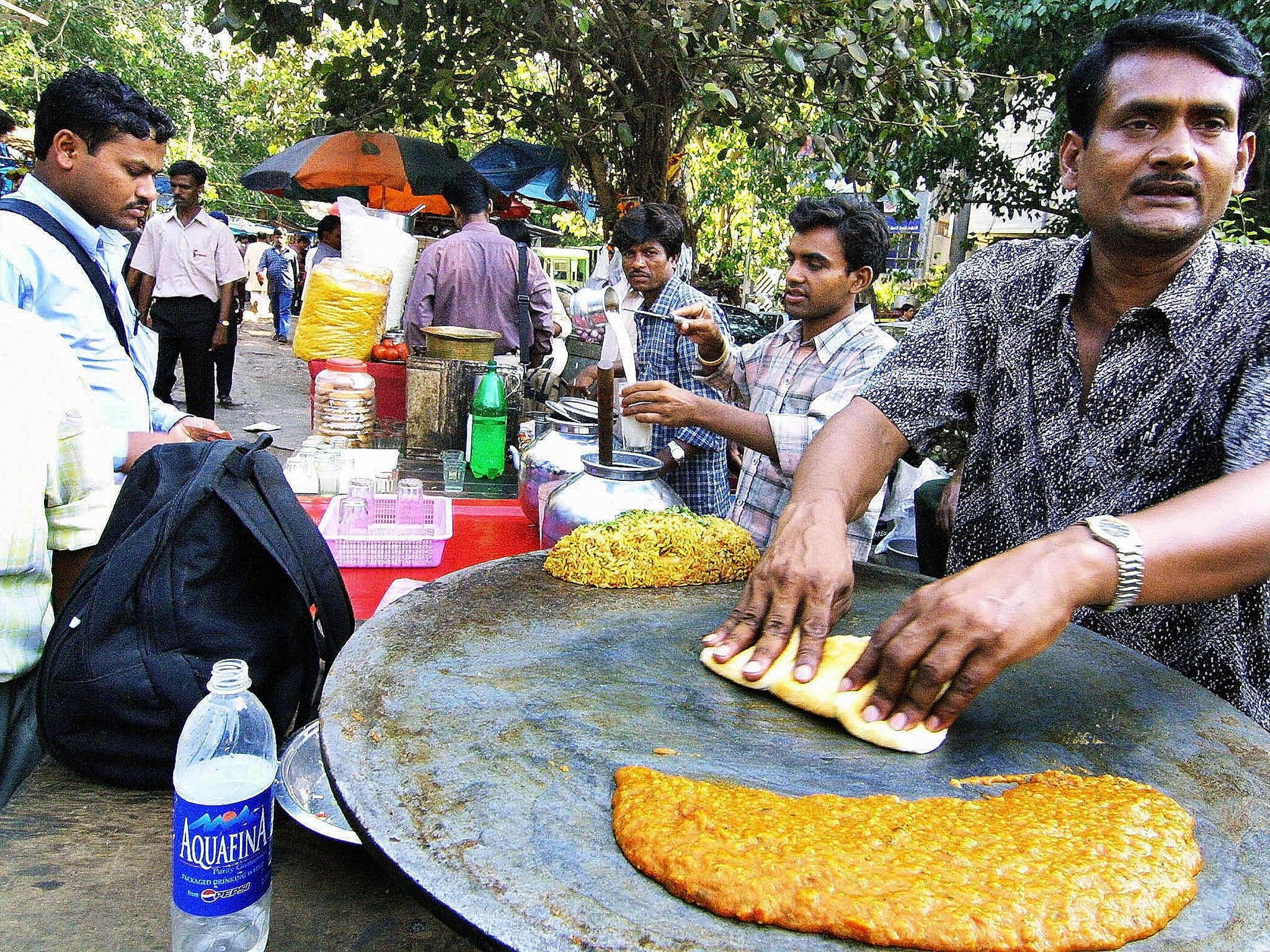 Indian hawker Feroze Chowdhary prepares pao-bhaji, a snack of bread and curry (Getty)