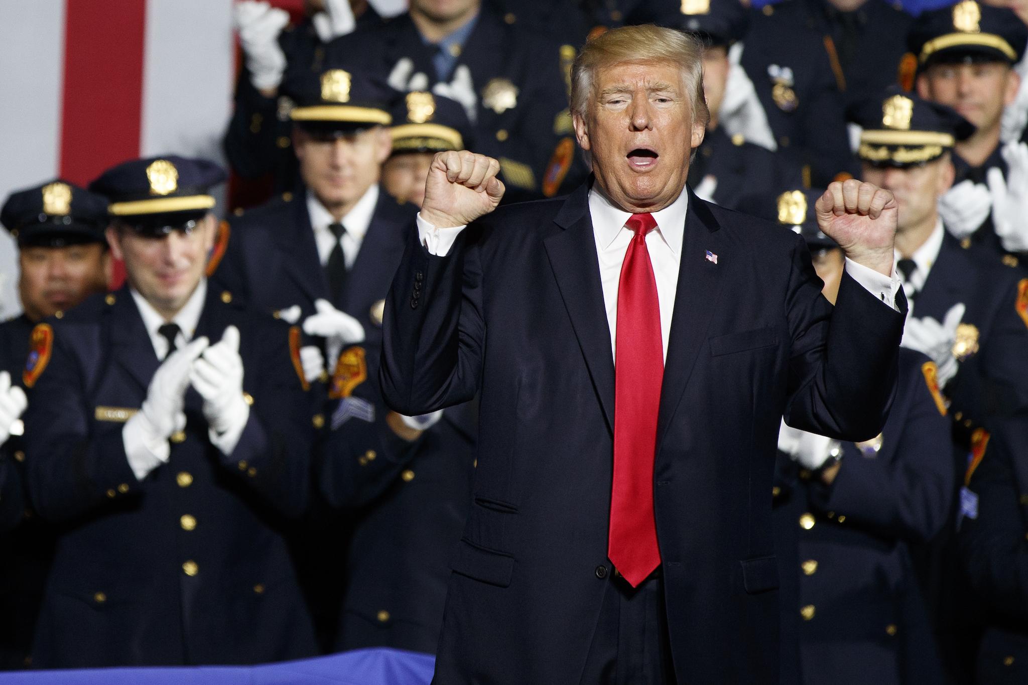 President Donald Trump pumps his fist after speaking to law enforcement officials