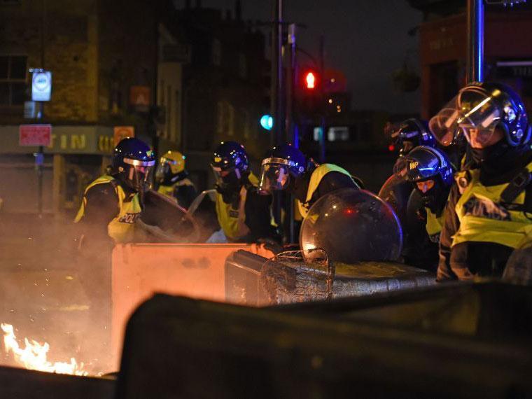 Riot police at a protest in Kingsland Road in east London, where people gathered in response to the death of Rashan Charles.