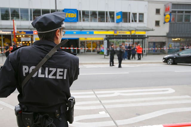 A police officer at the scene of the attack where one man was killed