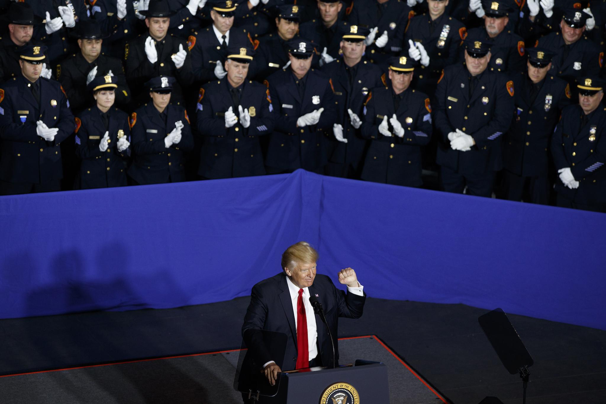 Law enforcement officers applaud President Donald Trump