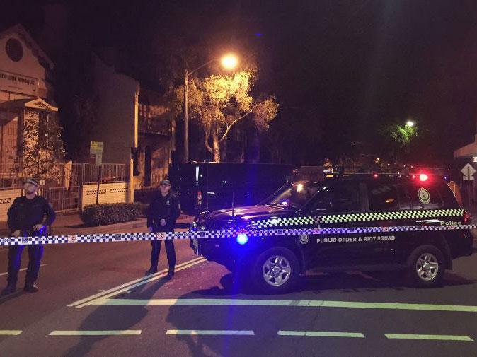 Police and forensic officers at the scene of a counter-terrorism raid on a property in Sydney