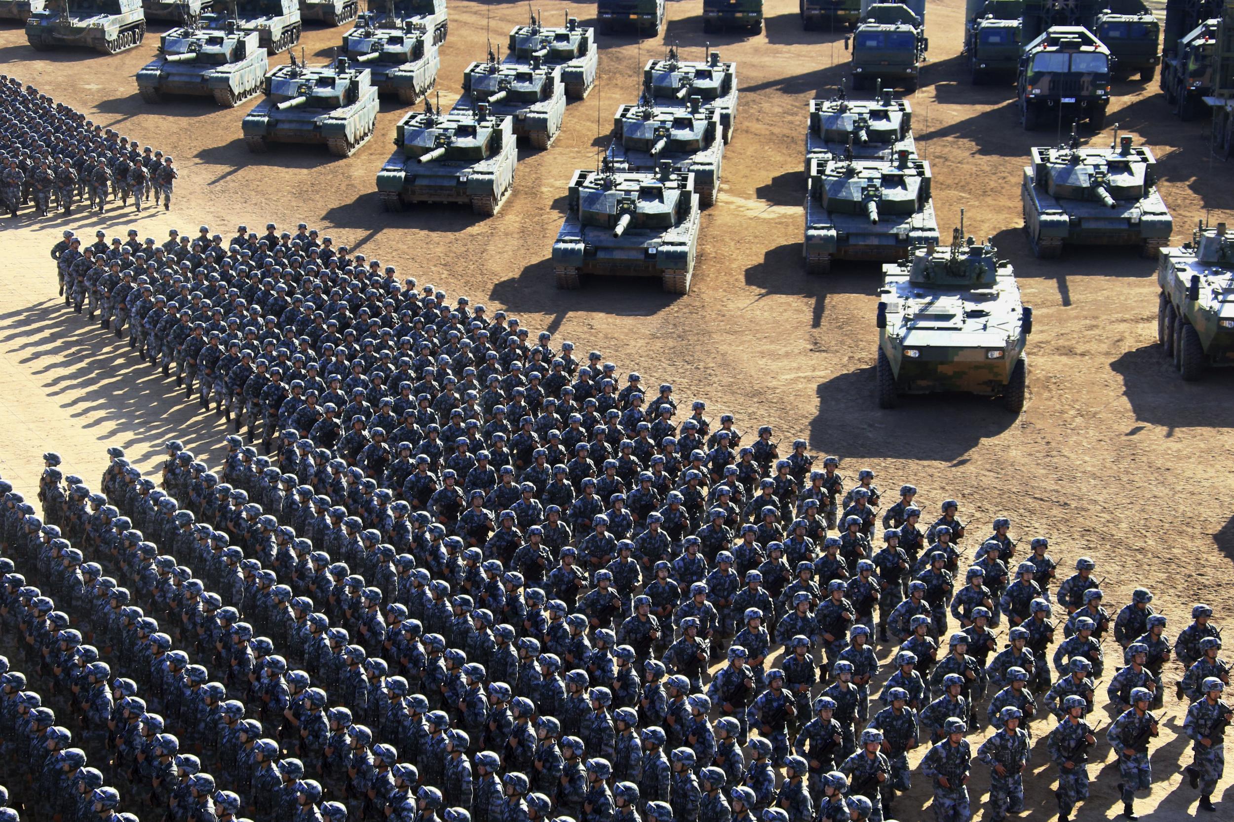 Chinese troops march past military vehicles in a massive show of firepower