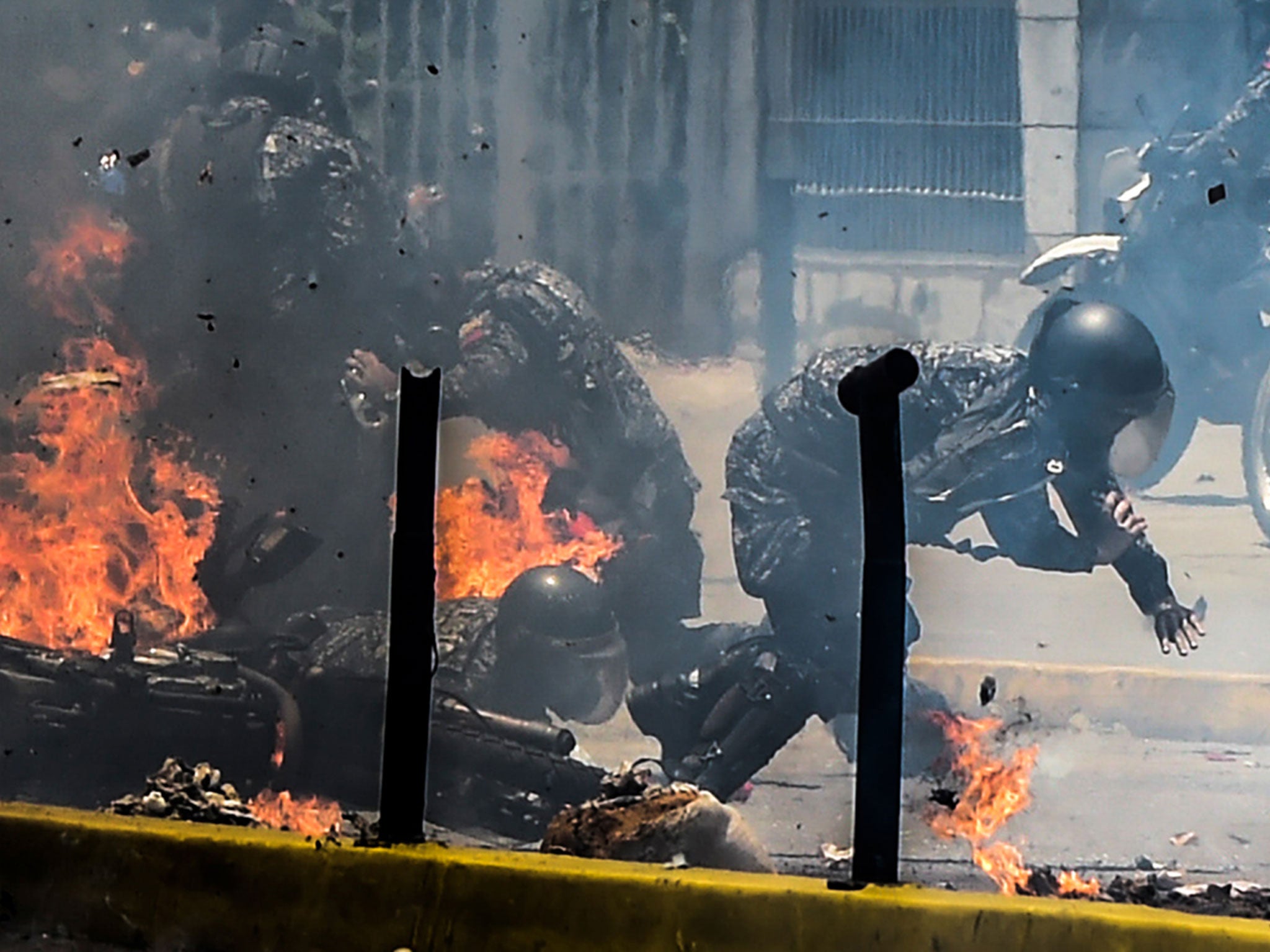 Police are targeted by an explosive device during a protest against the elections for a constituent assembly in Caracas on Sunday
