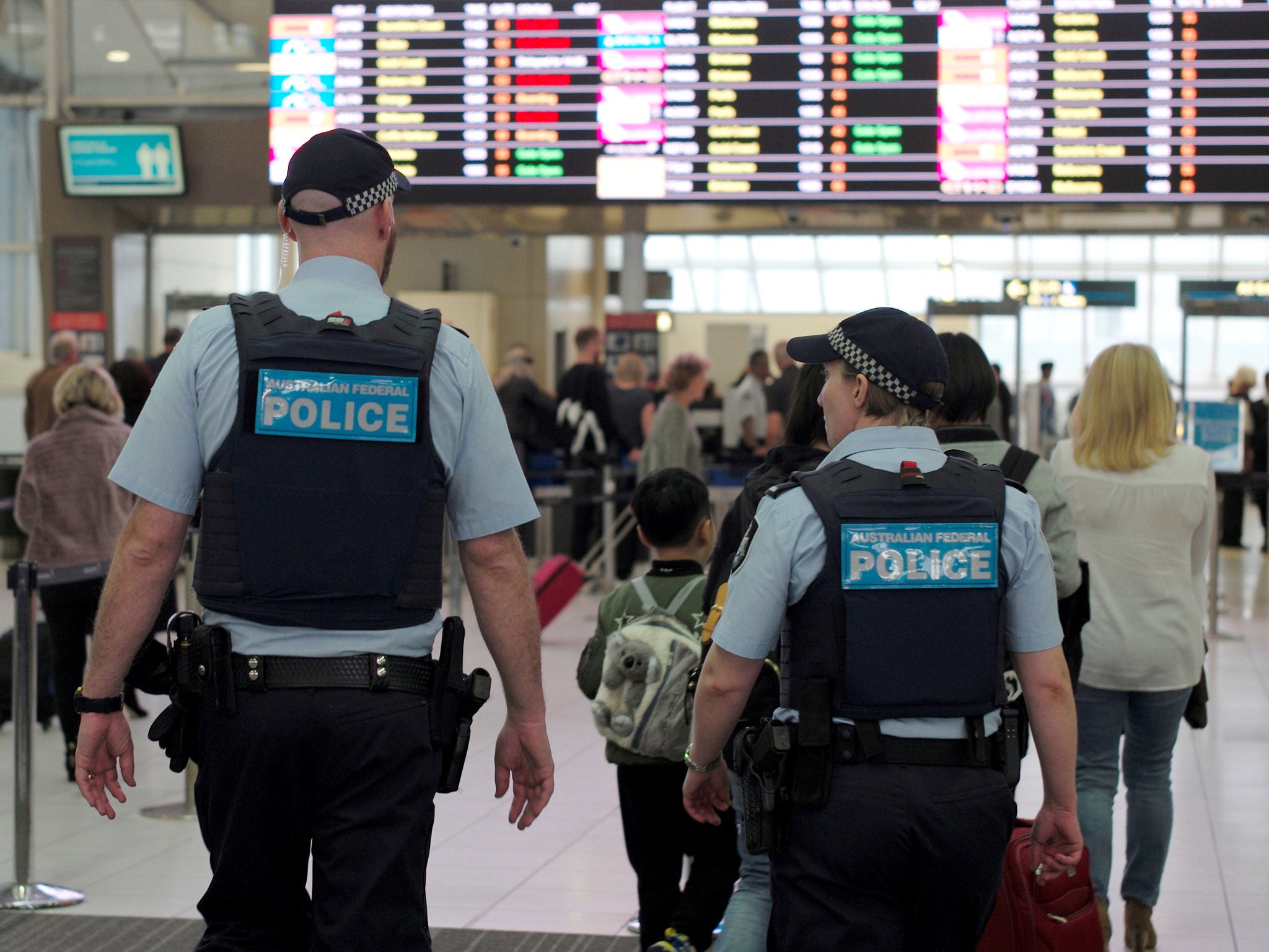 Australia Federal Police officers patrol the security lines at Sydney's Domestic Airport