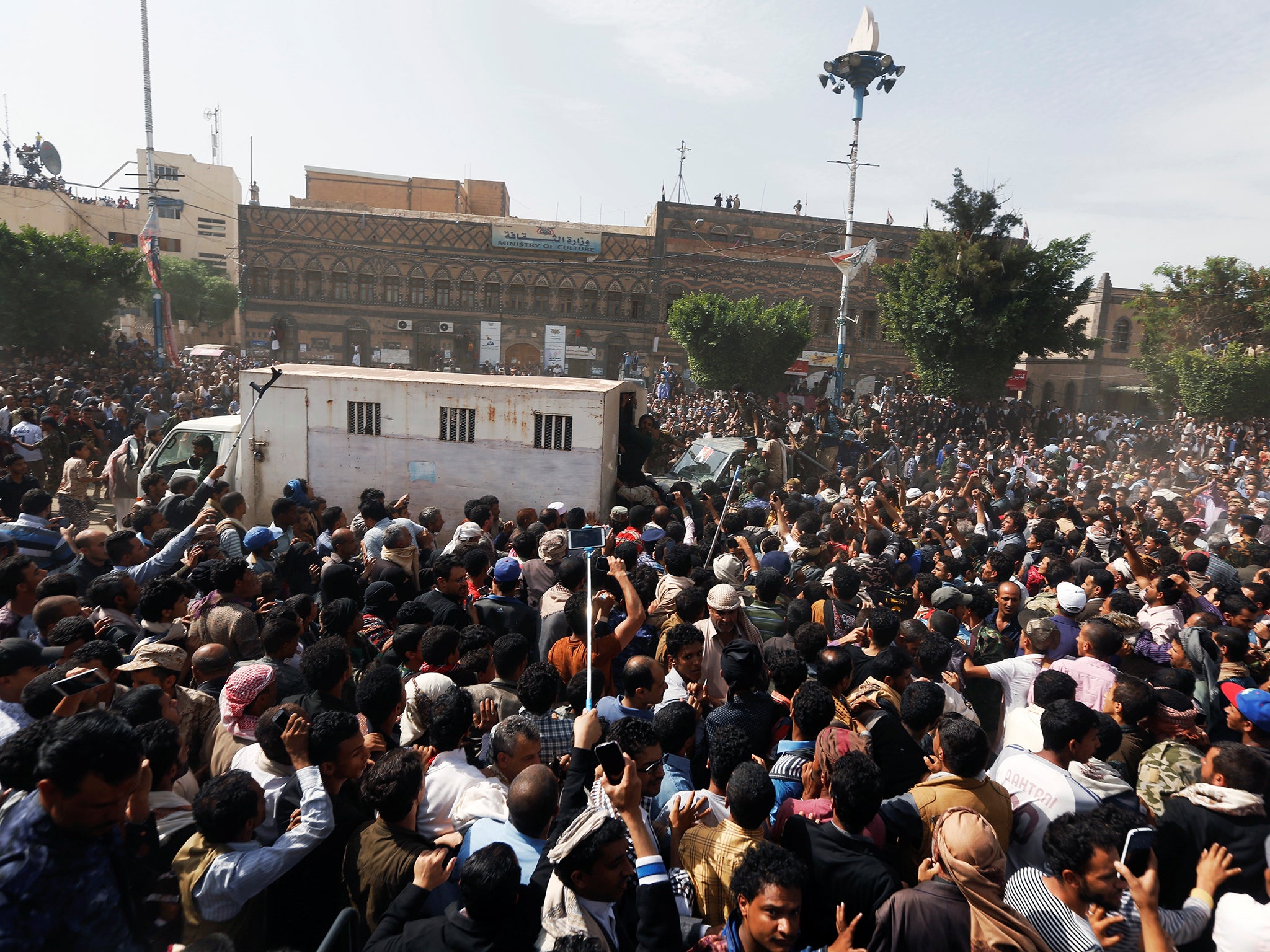 People gather around a police truck carrying the body of Muhammad al-Maghrabi, 41, after he was executed (REUTERS/Khaled Abdullah )