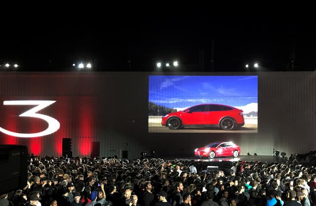 Tesla introduces one of the first Model 3 cars off the Fremont factory's production line during an event at the company's facilities in Fremont, California