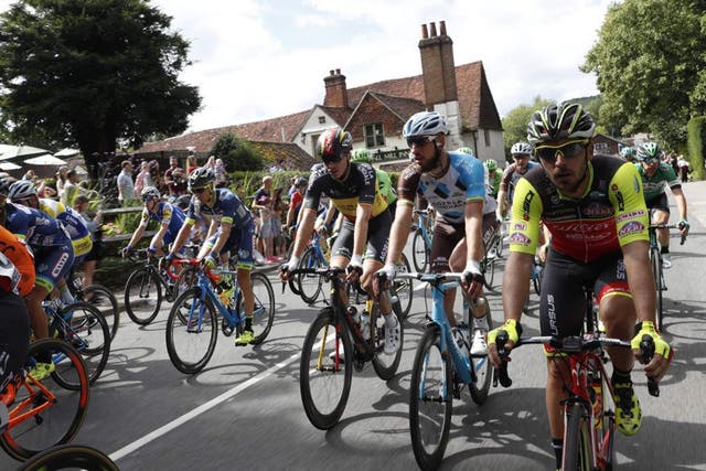 RideLondon riders cycling through a Surrey village on the route