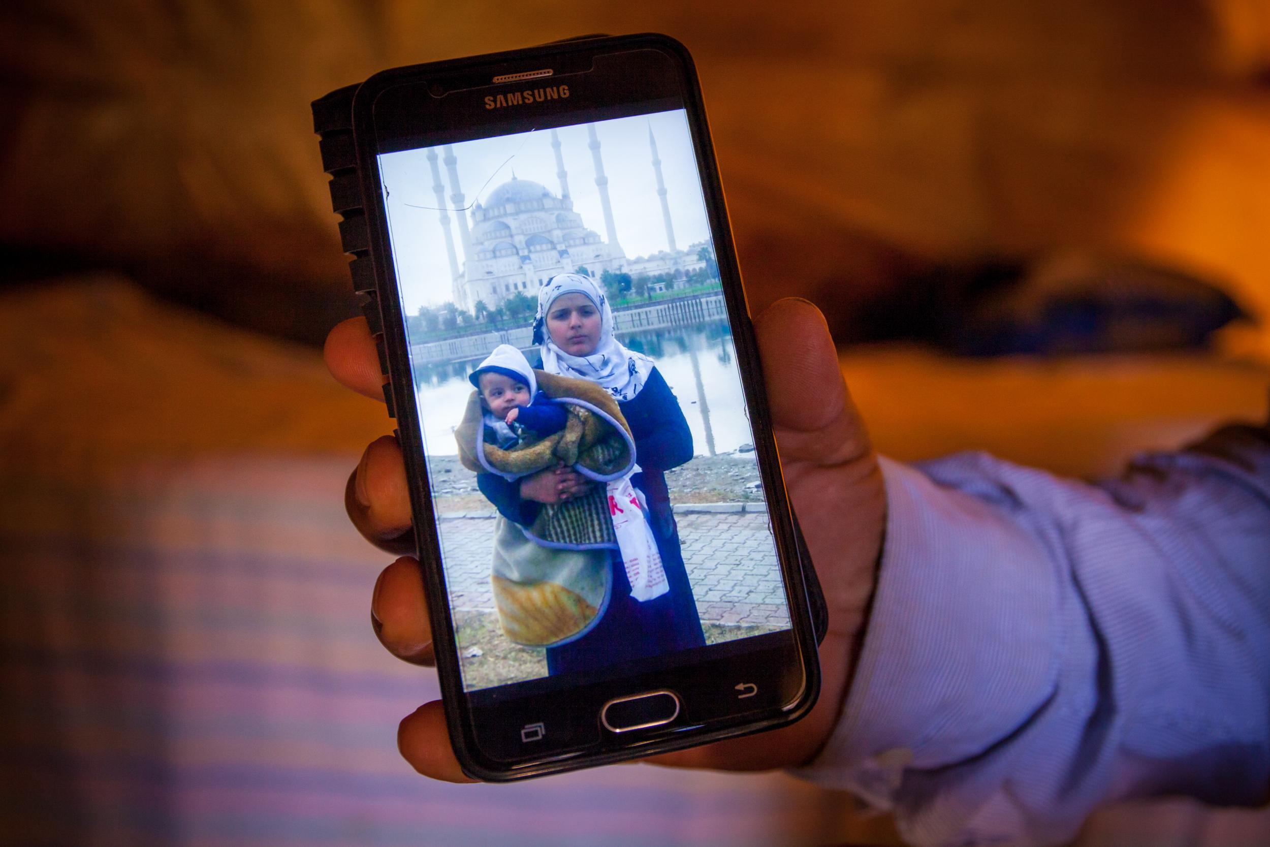 &#13;
'It had been four years that I didn’t know anything about her,' Mohammed said, eagerly showing photos on his phone of Reem, her husband and two young children in Turkey (Louise Norton)&#13;