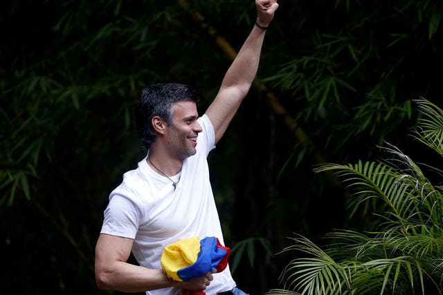 Venezuelan opposition leader Leopoldo Lopez, who was granted house arrest after more than three years in jail, salutes supporters in Caracas, Venezuela