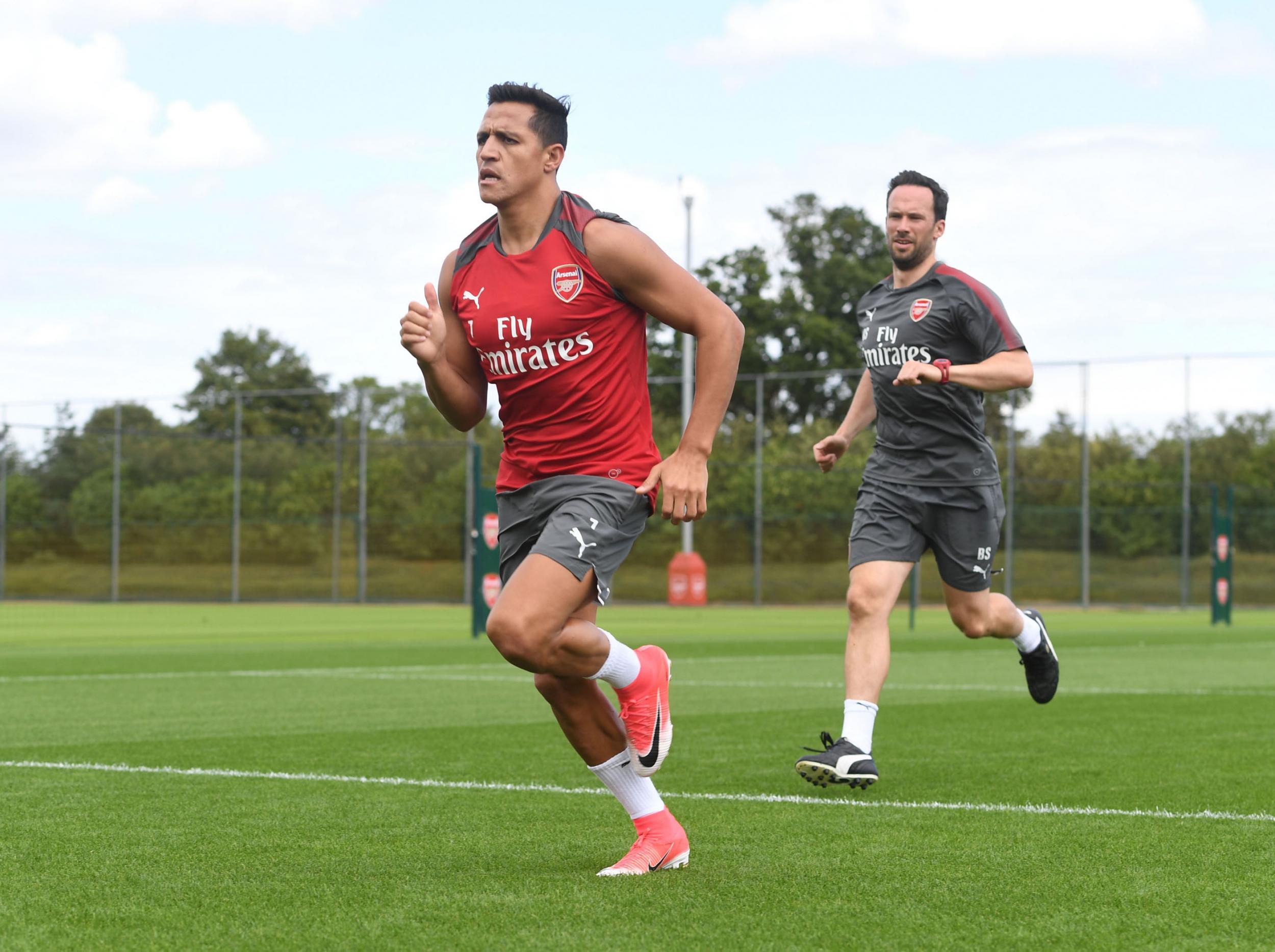 Sanchez was pictured at training with Arsenal fitness coach Barry Solan