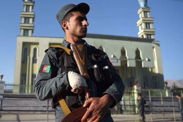 An Afghan policeman outside a Shia mosque in Kabul following a terror attack. The country has been on high alert in the past year as Isis has stepped up sectarian attacks