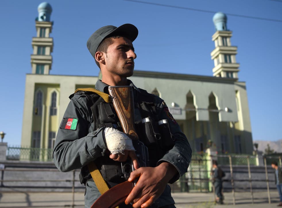 An Afghan policeman outside a Shia mosque in Kabul following a terror attack. The country has been on high alert in the past year as Isis has stepped up sectarian attacks