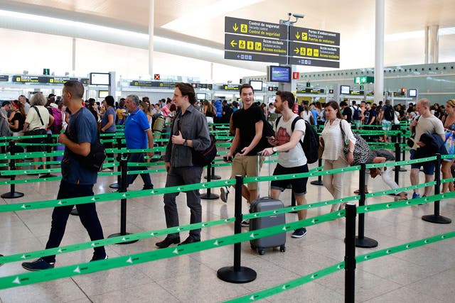 Passengers queue at Barcelona airport after tougher EU border checks left British holidaymakers facing long waits