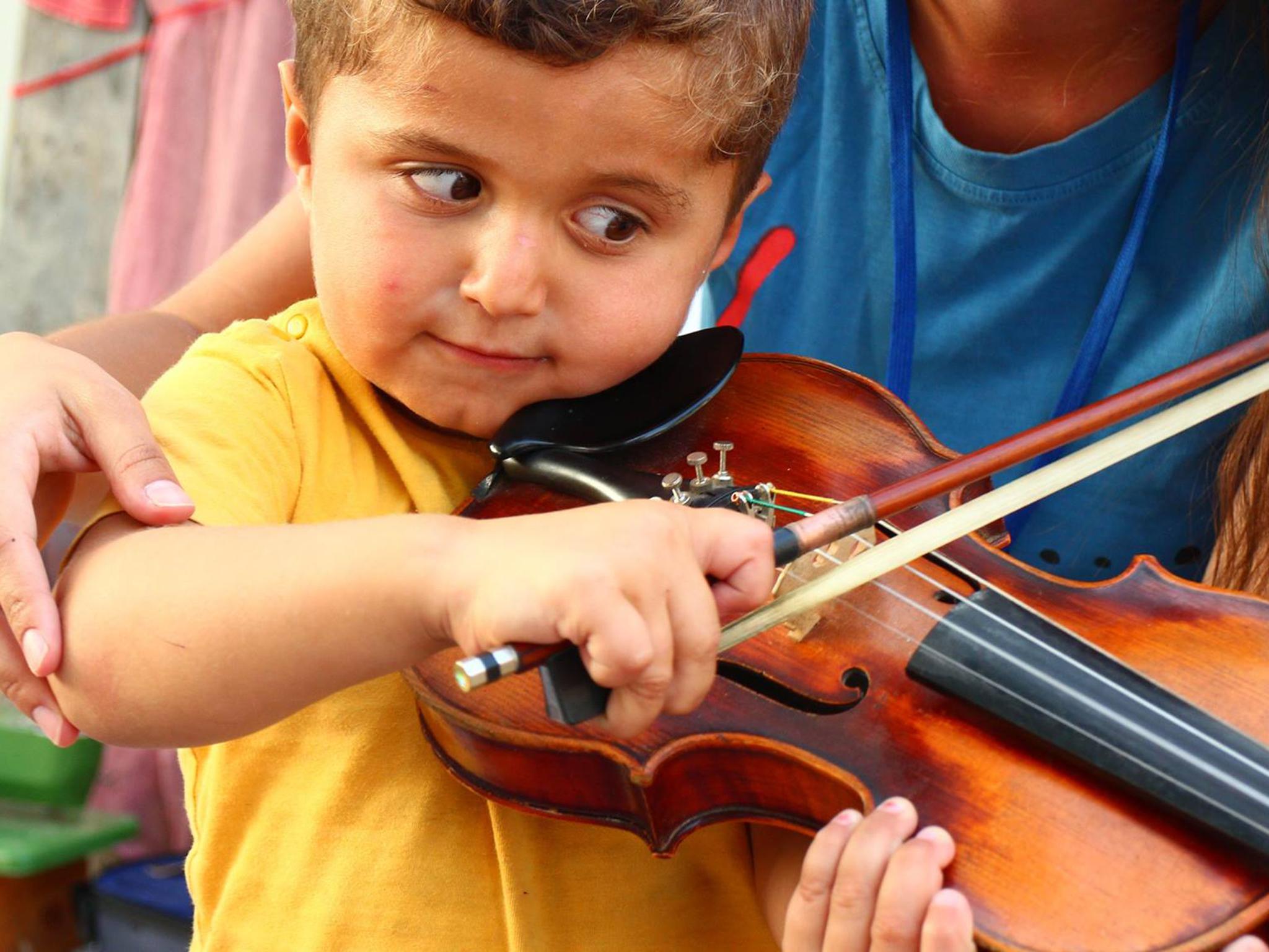 Violin lessons offer a welcome distraction for the children (Angels Relief Team)