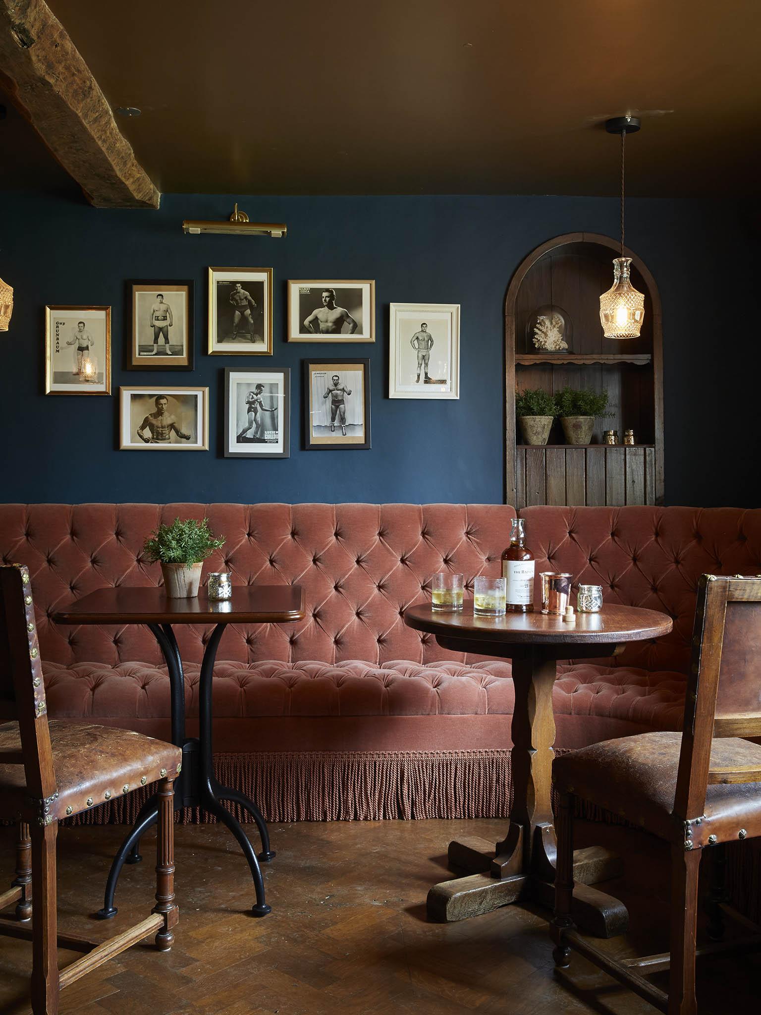 Old-school charm: the restaurant’s dusky pink sofa seating contrasts with the dark blue walls