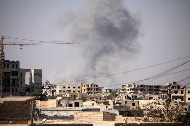 Smoke rises from a building in Raqqa, Syria on 31 July 2017