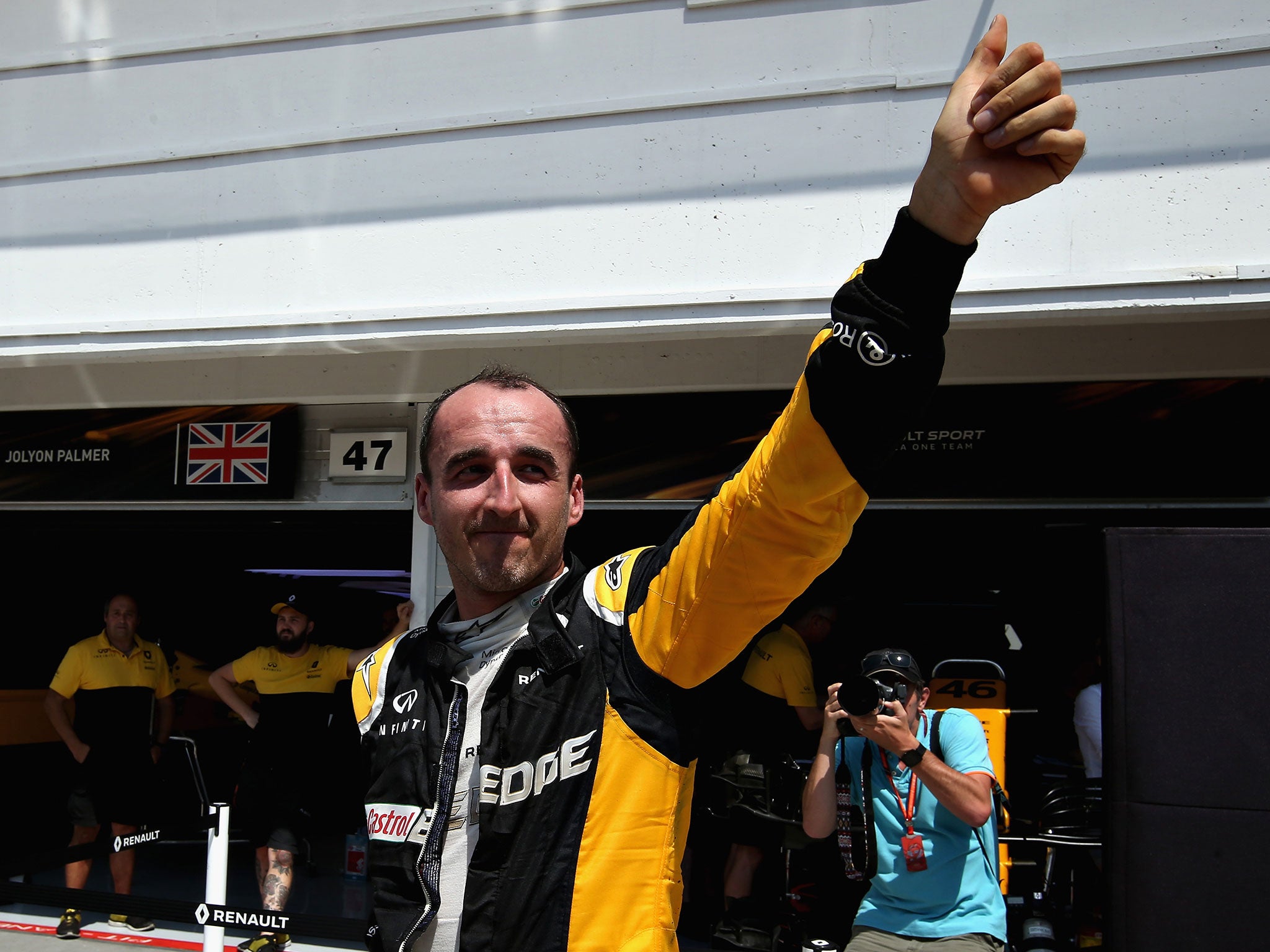 Robert Kubica waves to the crowd from the pit lane during day two at the Hungaroring