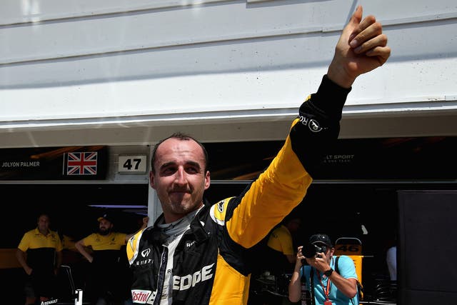 Robert Kubica waves to the crowd from the pit lane during day two at the Hungaroring 
