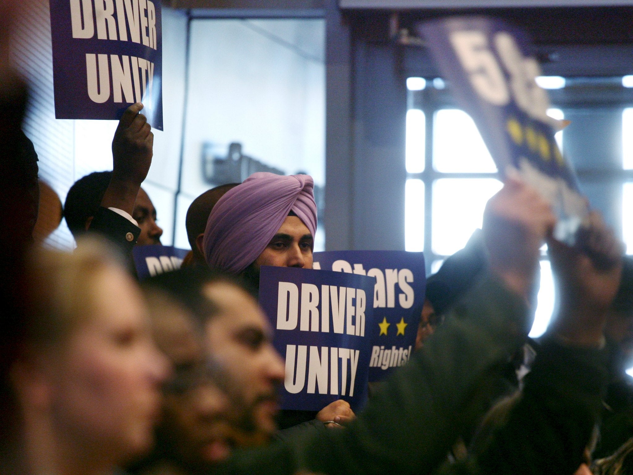 Backers of a Seattle ordinance allowing ride-for-hire drivers to unionize cheer as the City Council votes in favor on Dec. 15, 2015