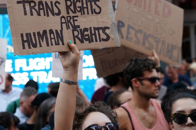 Demonstrators protest President Donald Trump's announcement on Twitter that he would ban transgender people from serving in the military 'in any capacity.'