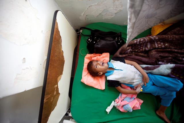 A boy cries as he lies on a bed of a hospital in Sanaa, Yemen on 27 July, 2017. Less than half of the country's medical facilities are functional in the face of a huge cholera epidemic