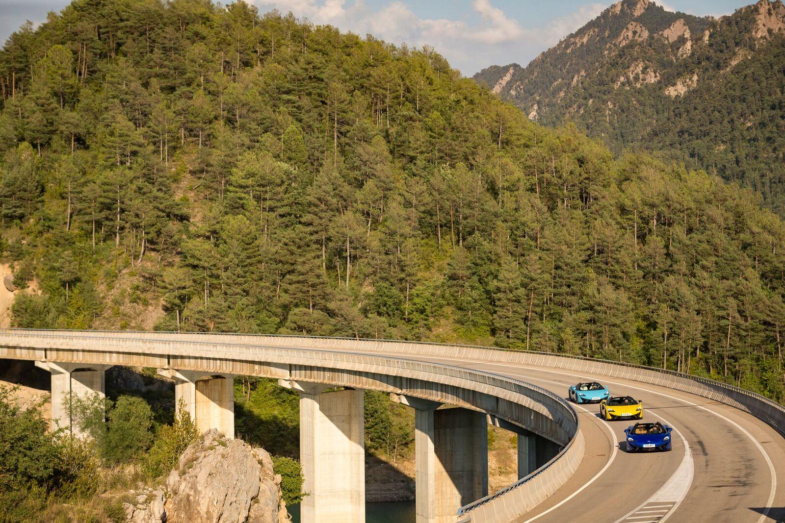 A convoy of cars cut across the Spanish landscape