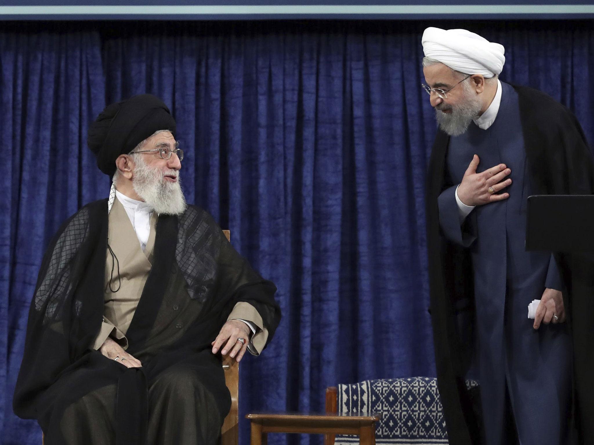 Iranian supreme leader Ayatollah Ali Khamenei (left) and President Hassan Rouhani greet at the official endorsement ceremony of President Rouhani in Tehran