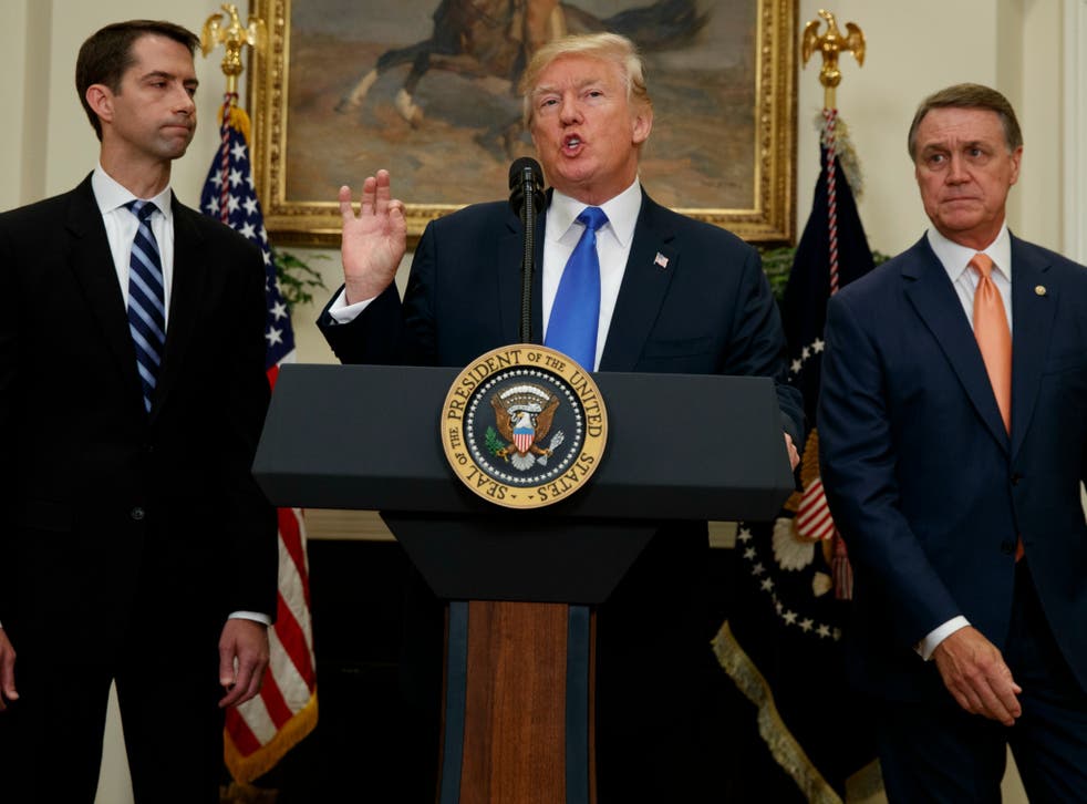 President Trump, flanked by Sen. Tom Cotton, R-Ark, and Sen. David Perdue, R-Ga, unveils an immigration bill that met skepticism from the technology industry.