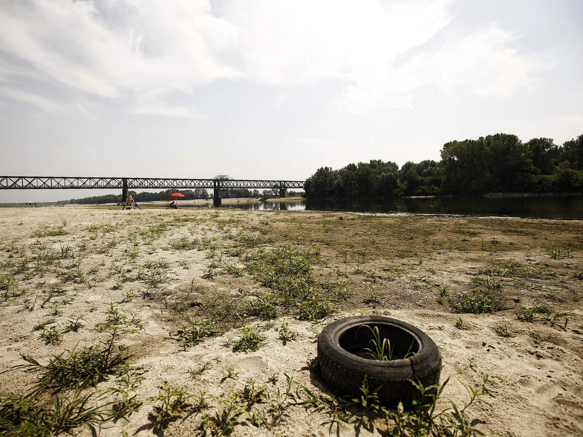 &#13;
A car tire lies on a dry sandbank near the Po River near the Ponte della Becca bridge in Linarolo, near Pavia, northern Italy, on August 1, 2017, after the country was affected by a heat wave and drought. &#13;