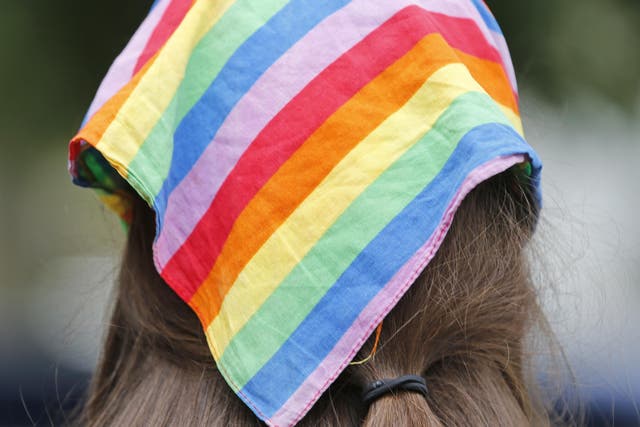 A woman wears a rainbow scarf symbolising LGBTQ pride