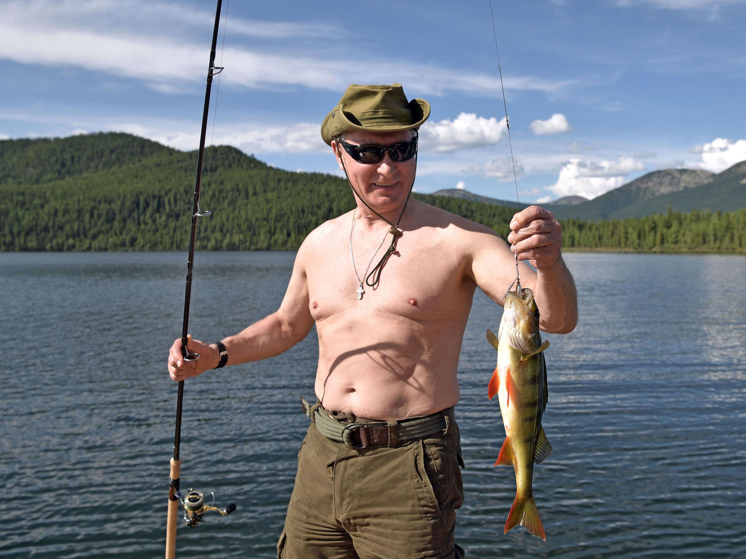 Putin with a perch, this time caught by rod and line fishing (Getty)