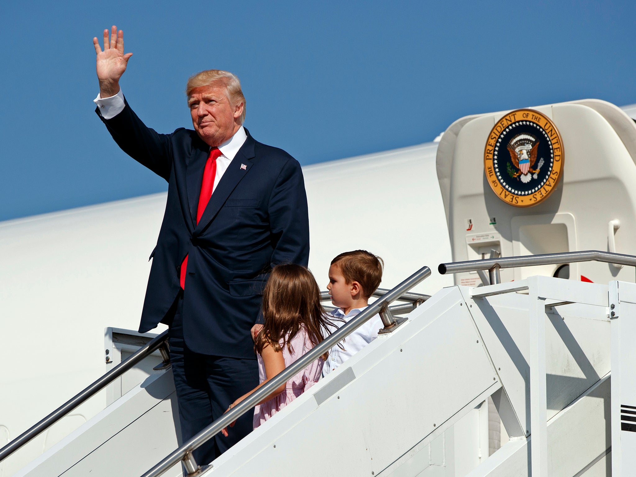 President Trump alights Air Force One with his grandchildren after arriving at Morristown Municipal Airport