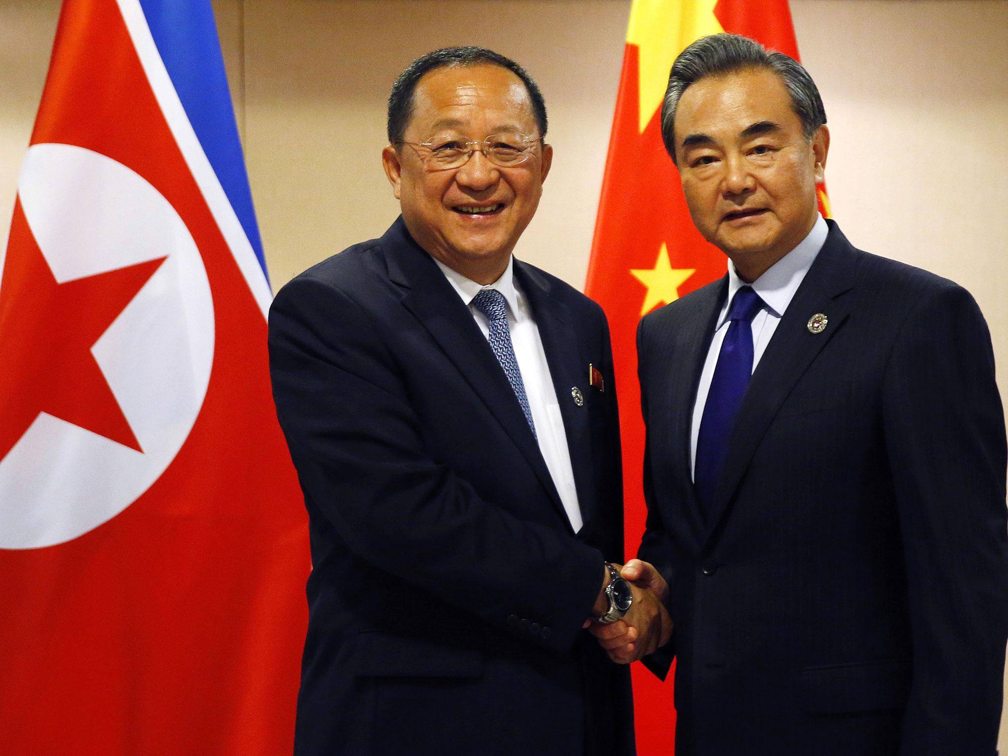 North Korean Foreign Minister Ri Yong Ho (left) poses with his Chinese counterpart Wang Yi for a photo prior to their bilateral meeting in the sideline of the 50th ASEAN Foreign Ministers' Meeting and its Dialogue Partners, in Pasay city, south Manila, Philippines