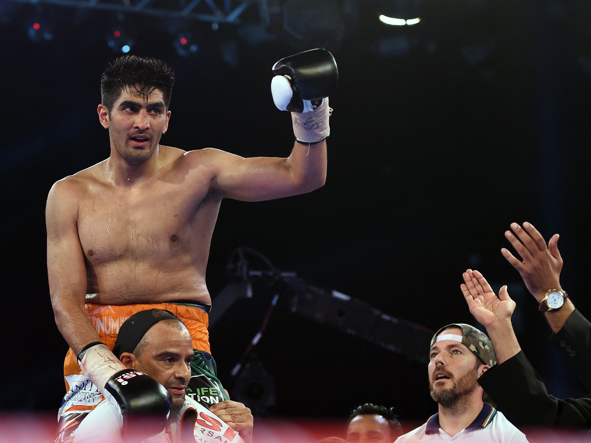 Indian boxer and WBO Asia-Pacific Super Middleweight champion Vijender Singh celebrates after winning the double title bout against China's Zulpikar Maimaitiali at the National Sports Complex of India (NSCI) Dome in Mumbai on August 5, 2017. / AFP PHOTO / PUNIT PARANJPEPUNIT PARANJPE/AFP/Getty Images (AFP )