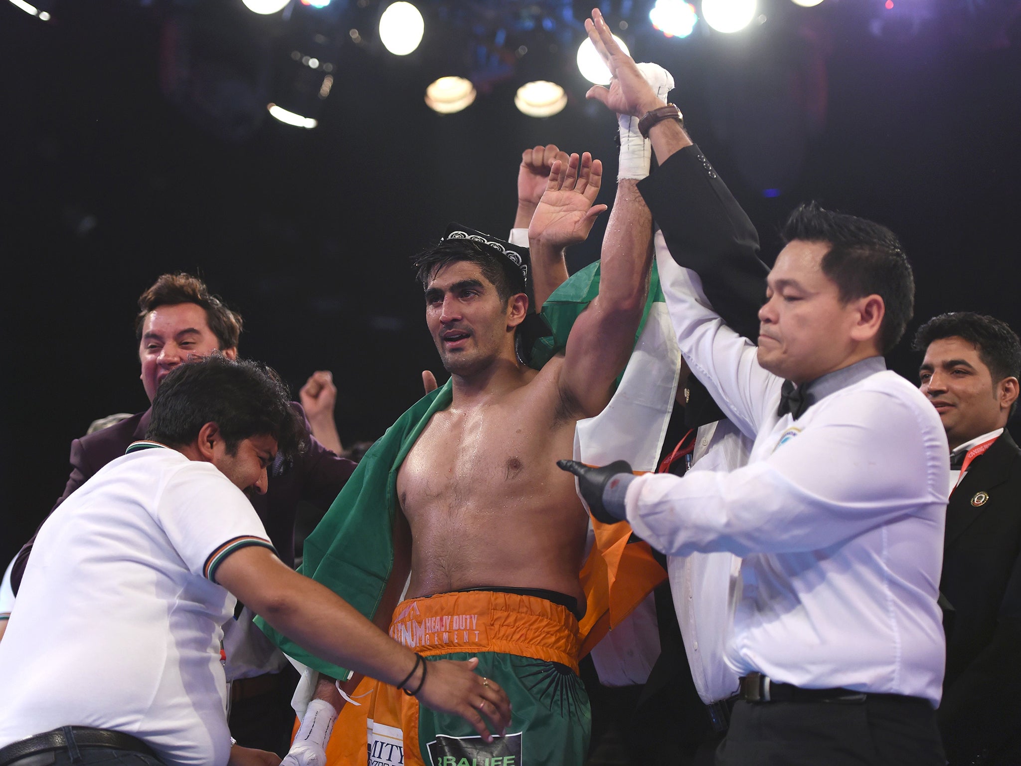 Indian boxer and WBO Asia-Pacific Super Middleweight champion Vijender Singh (C) celebrates after winning the double title bout against China's Zulpikar Maimaitiali at the National Sports Complex of India (NSCI) Dome in Mumbai on August 5, 2017. / AFP PHOTO / PUNIT PARANJPEPUNIT PARANJPE/AFP/Getty Images (AFP )