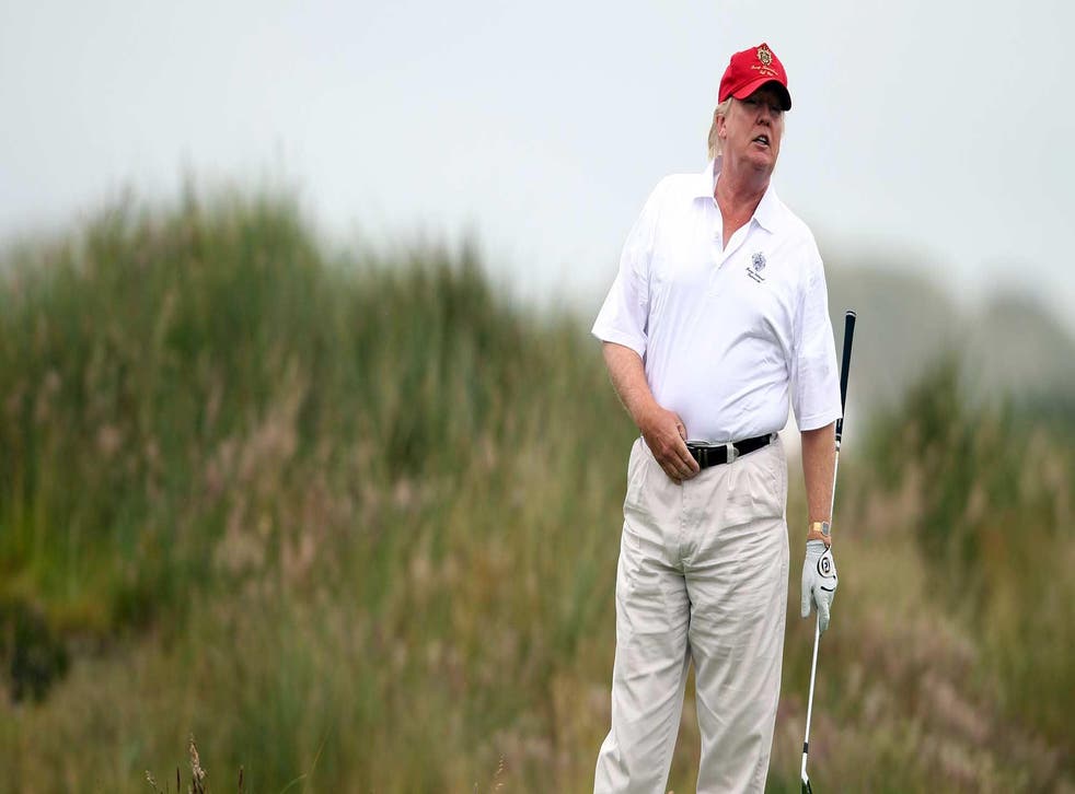 Mr Trump enjoys a round of golf at his Bedminster, New Jersey golf club - but claims he is not on holiday