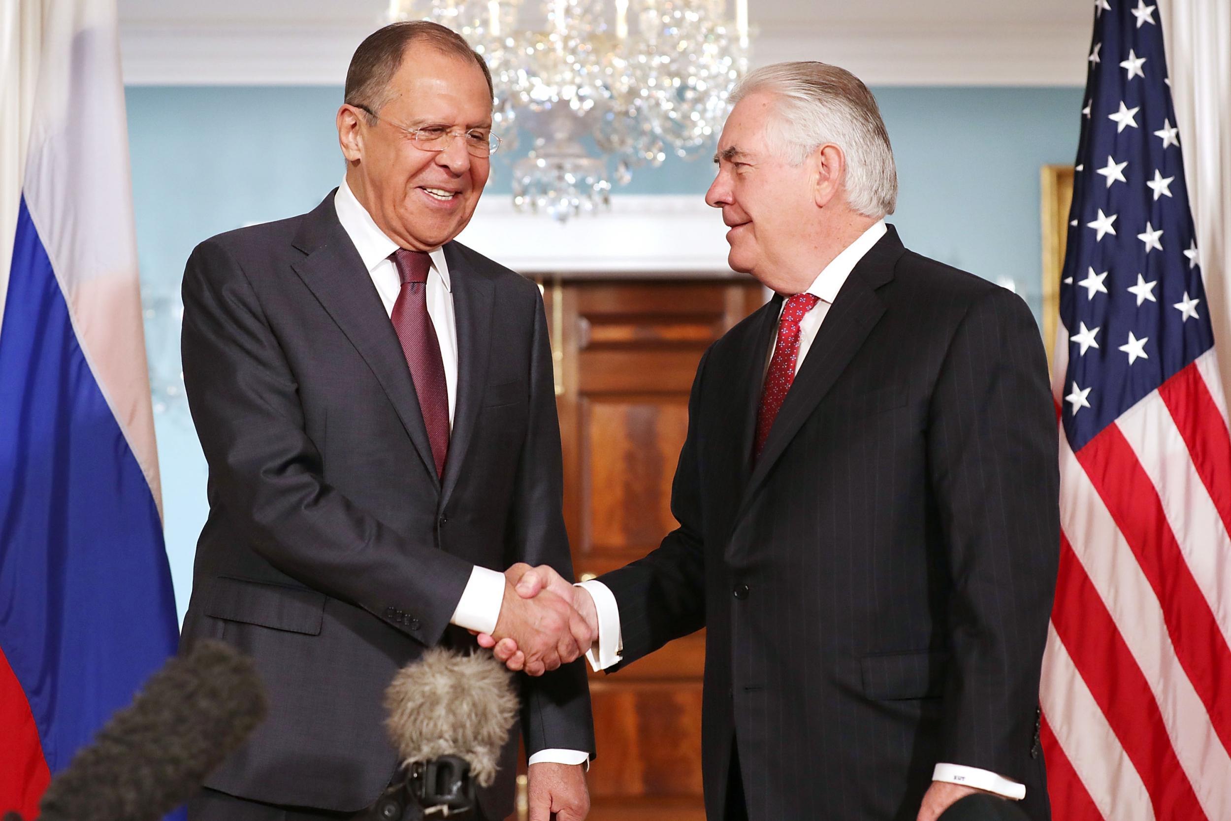 Russian Foreign Minister Sergey Lavrov and US Secretary of State Rex Tillerson shake hands in the Treaty Room before heading into meetings at the State Department